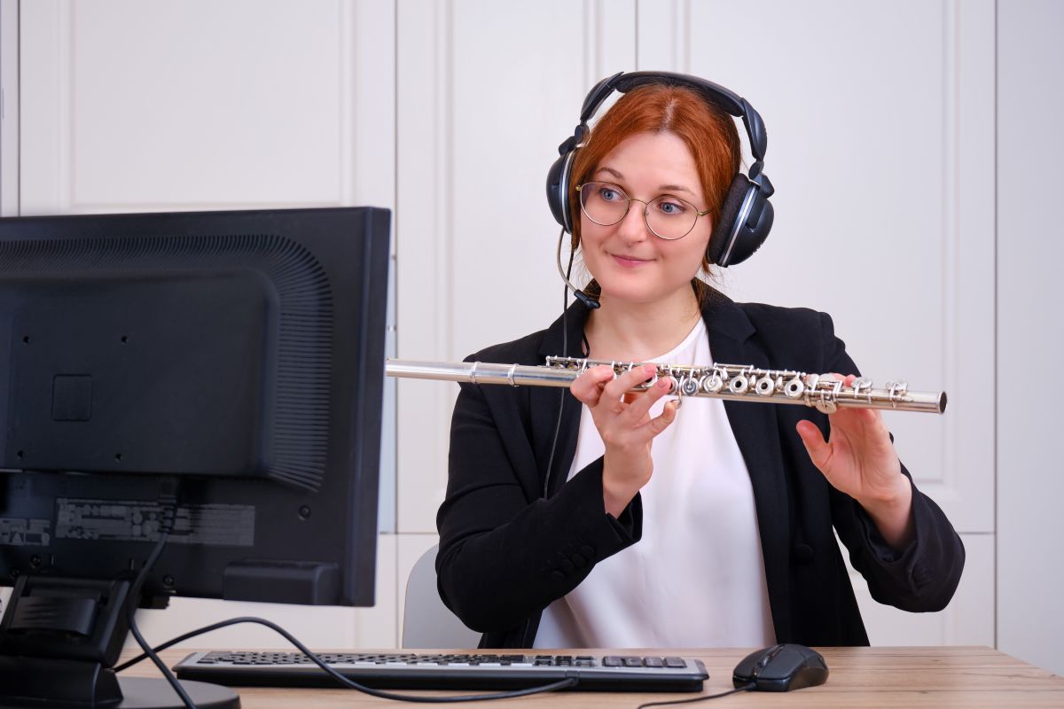 A woman during a Zoom call taking an online Flute lesson